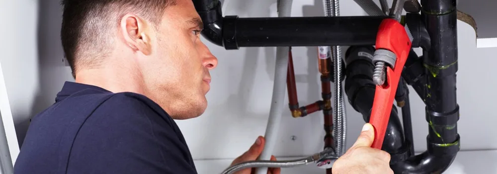 Plumber on the job while the plumbing business grows