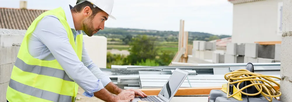 A commercial subcontractor checks the schedule of values against the drawings before billing.