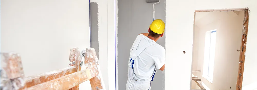 A paint roller and ladder mid job, the partially complete work that progress billing turns into steady cash flow