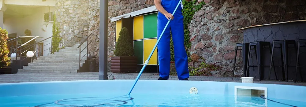 A pool tech works a weekly service stop, the kind of recurring visit that turns one job into steady revenue